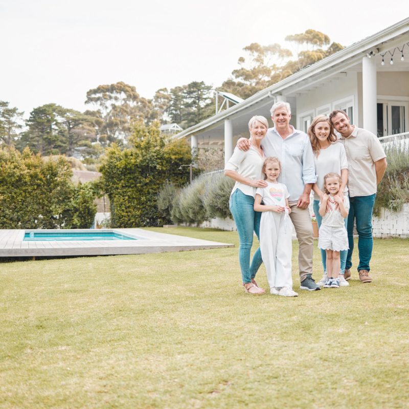 Happy cheerful family standing together outside in the garden. Family relaxing outdoors with their .