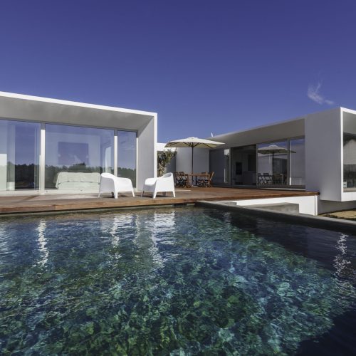 Modern house with garden swimming pool and wooden deck