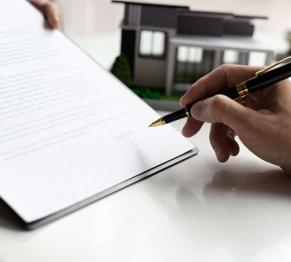 Real estate agents negotiate for businessmen to legally sign home purchase agreements contract , rent, mortgage, lease.